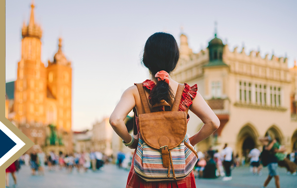 focus on the back of a female wearing a backpack in a foreign country on a study abroad experience