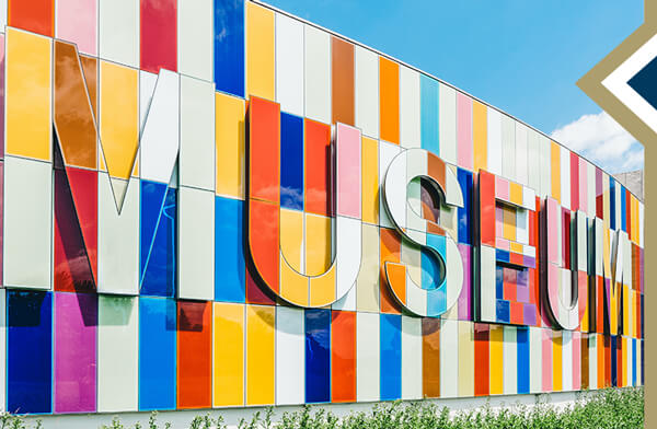 large, colorful sign composed of different colored rectangle tiles that says "MUSEUM"