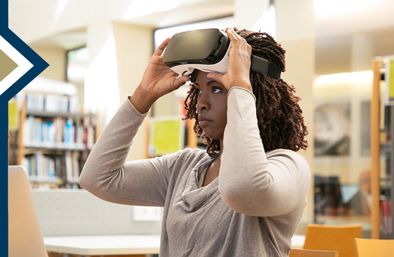 young professional puts on VR headset in library  - Image by pch.vector on Freepik
