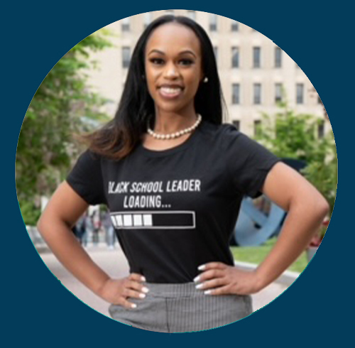 Arianna Allen poses for a professional photo wearing a shirt that reads &quot;Black School Leader Loading...&quot; with a progress bar beneath