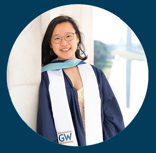 Jessica Lee poses for photo wearing GW stole and commencement regalia