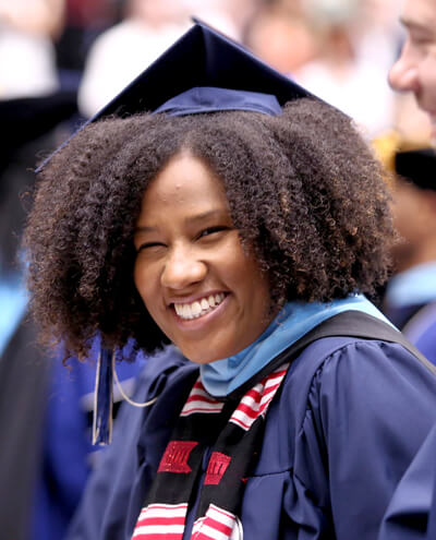 closeup of smiling GSEHD graduate at school celebration
