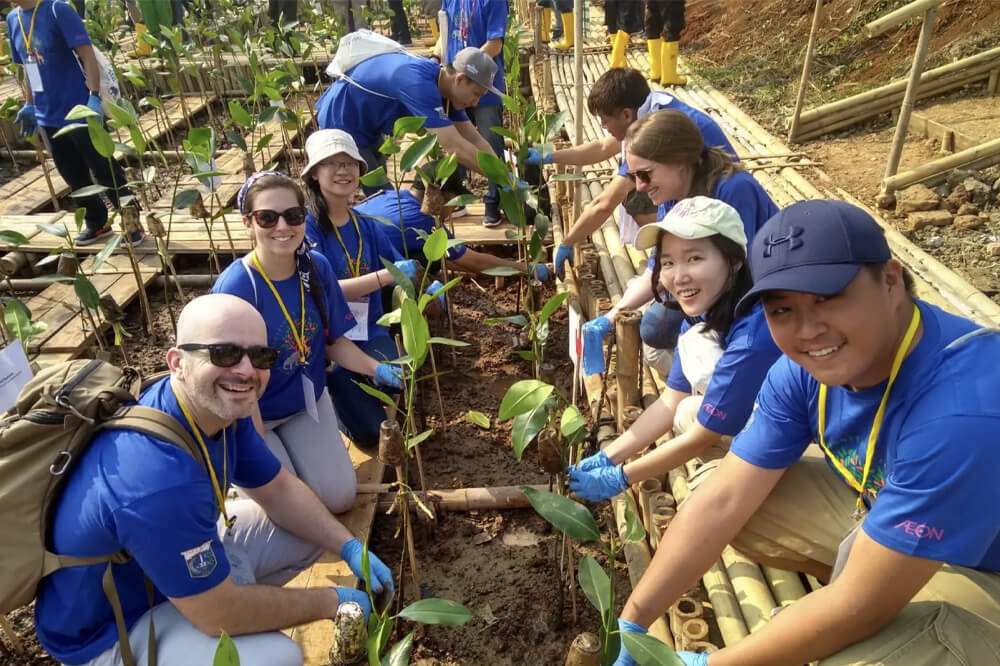 Jonathan Yoo volunteering with group to plant Mangroves in Jakarta