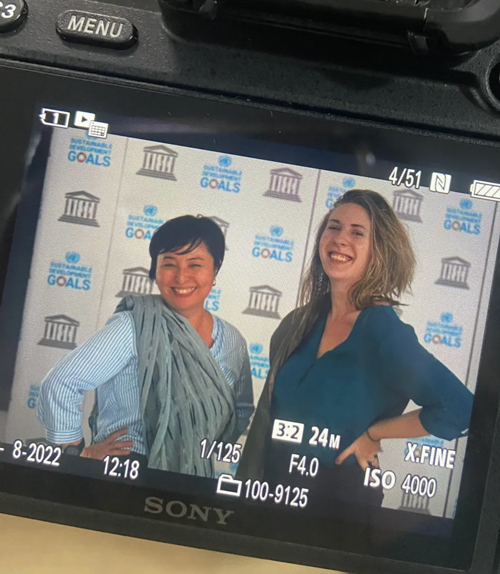 Photo of digital camera screen showing a preview of a photo of Hayley Pottle posing with a colleague
