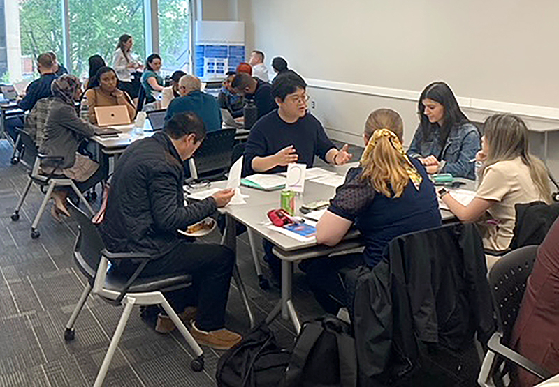 participants in the GSEHD Research Kaleidoscope discuss their projects in small groups
