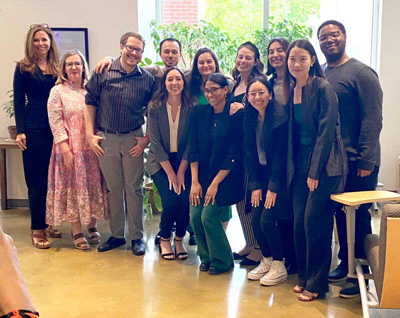 School counseling students and faculty pose for a group photo following the research symposium