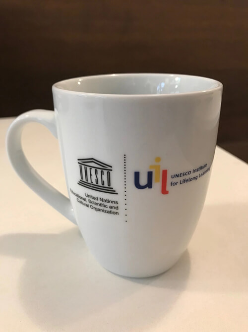 coffee cup branded with UNESCO ILL logo