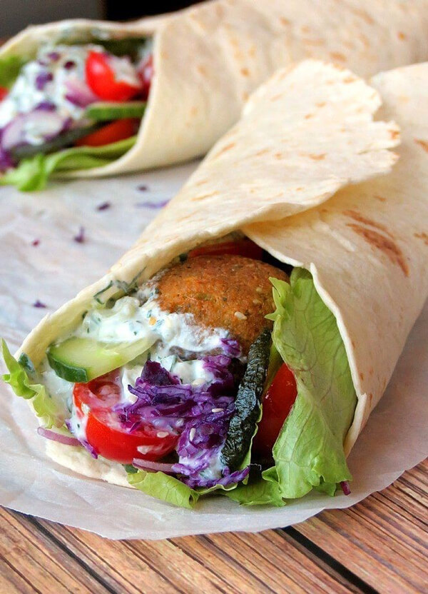 closeup of wrap with vegetables and a fried food