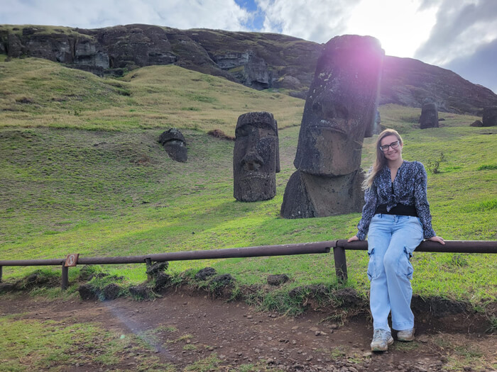 Caroline leans on fence to pose for photo at Rapa Nui (aka Easter Island)