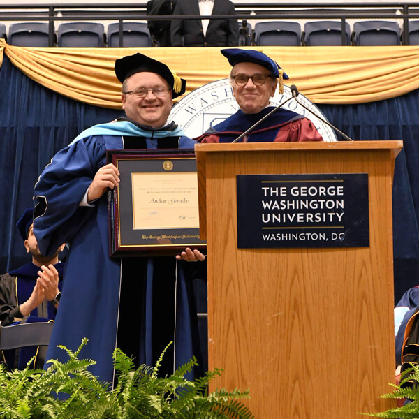 Dean Feuer presents Outstanding Alumni Award to Dr. Andrew M. Goretsky at 2024 Commencement Ceremony