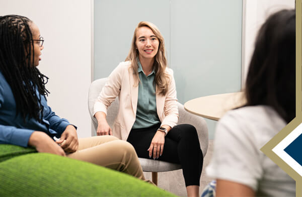 Department of Counseling and Human Development - counselor speaks to small group with their backs to the camera - Image by pch.vector on Freepik