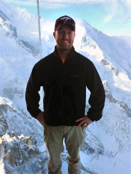 Dave Childress poses for a photo while hiking in the mountains covered in snow