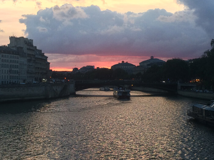 sunset on the Seine with boats floating down the river