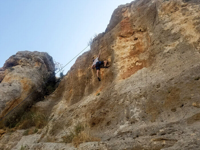 Justin Rotundo climbing at a crag in Fuheis