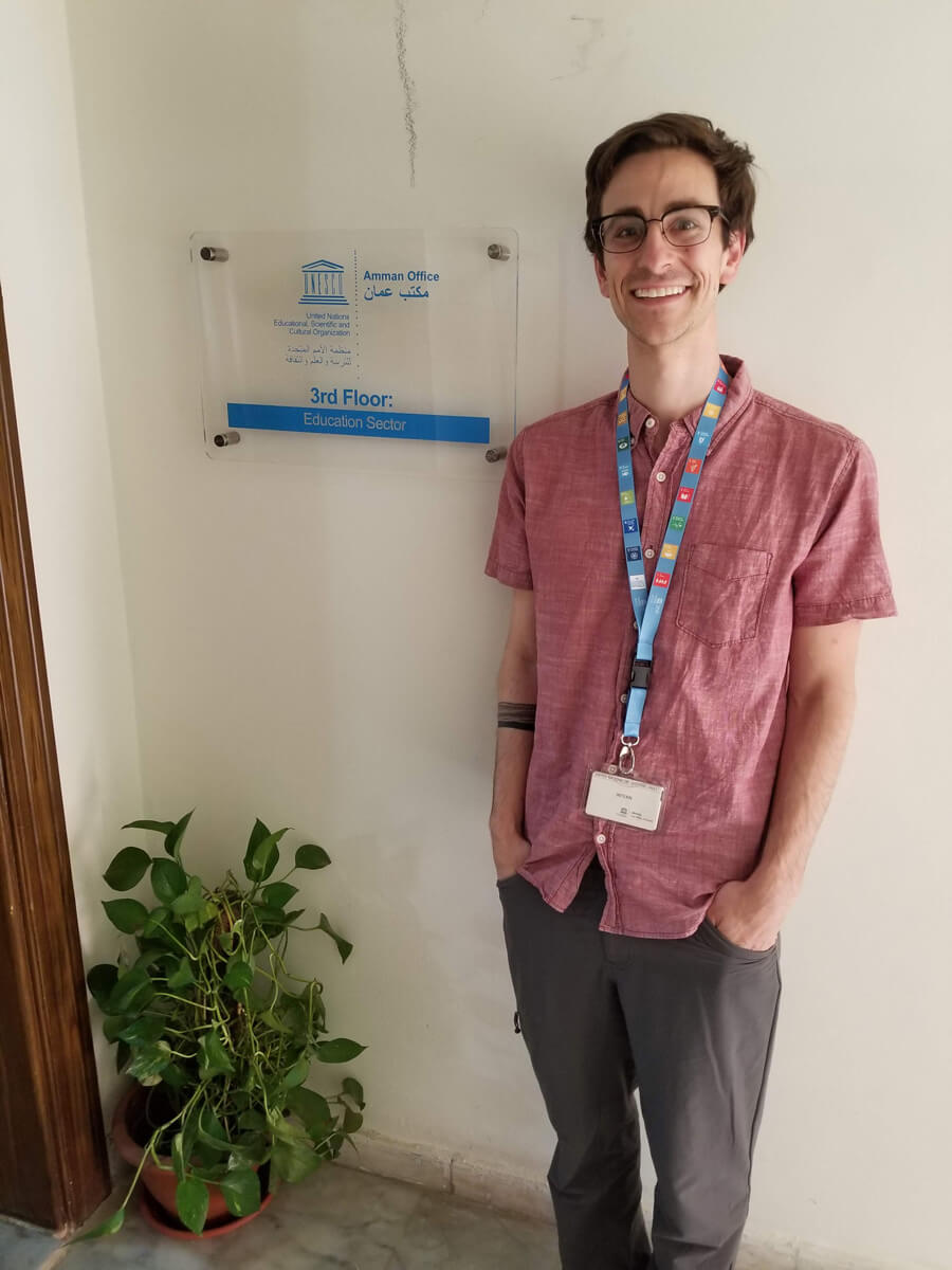 Justin poses for a photo outside the education unit’s office