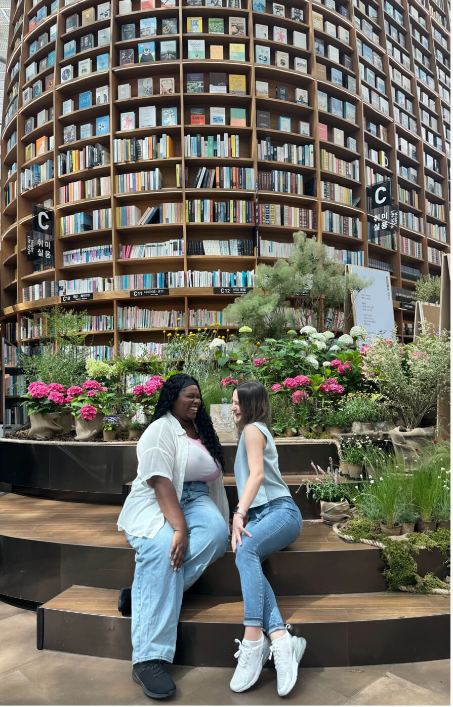 Tishkus poses with colleague, Michanda Aimé, inside the the Starfield Library
