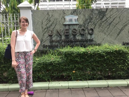 Brynn poses in front of the UNESO sign