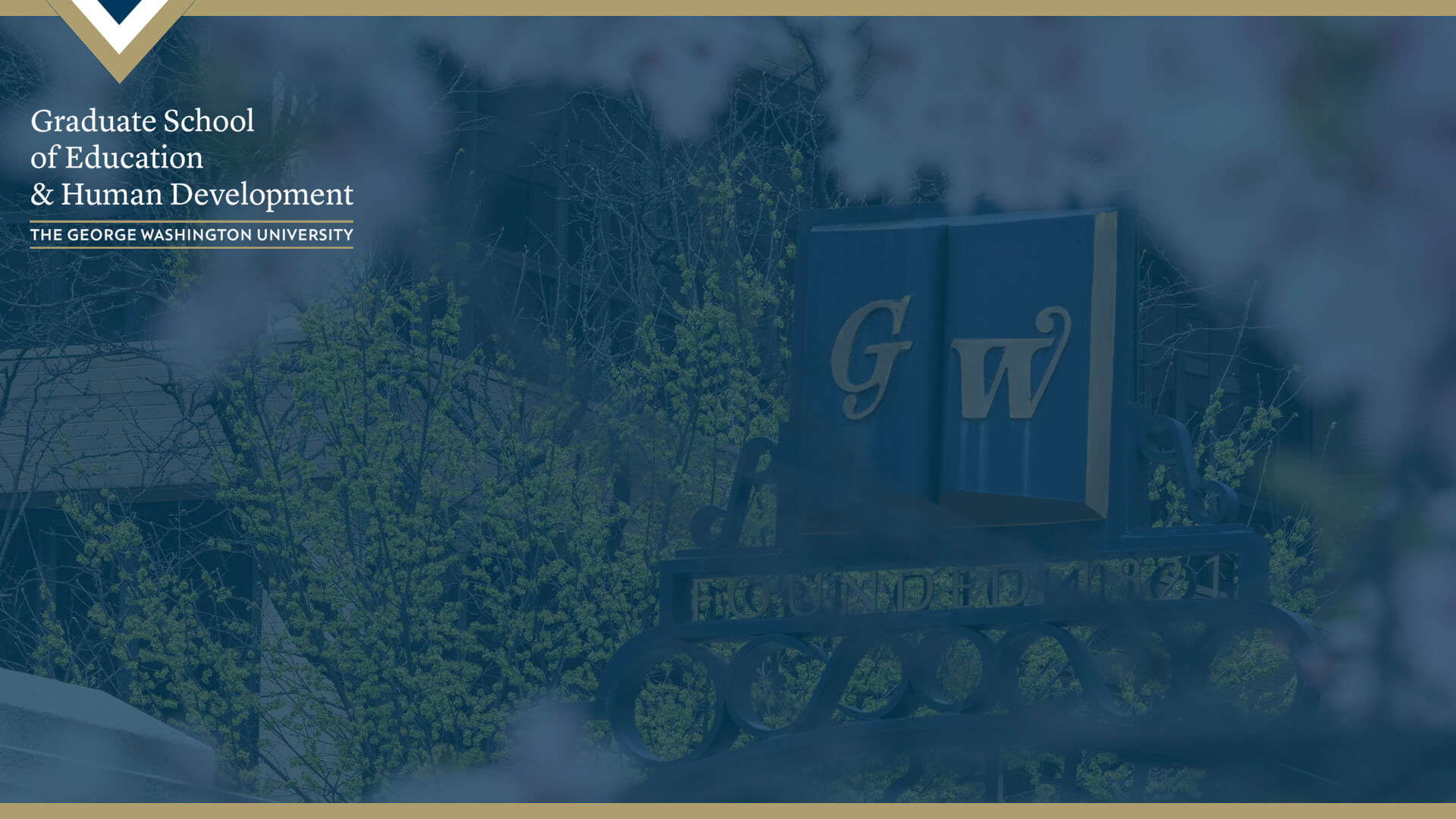 GW gate framed by cherry blossoms, Graduate School of Education and Human Development logo in top left corner