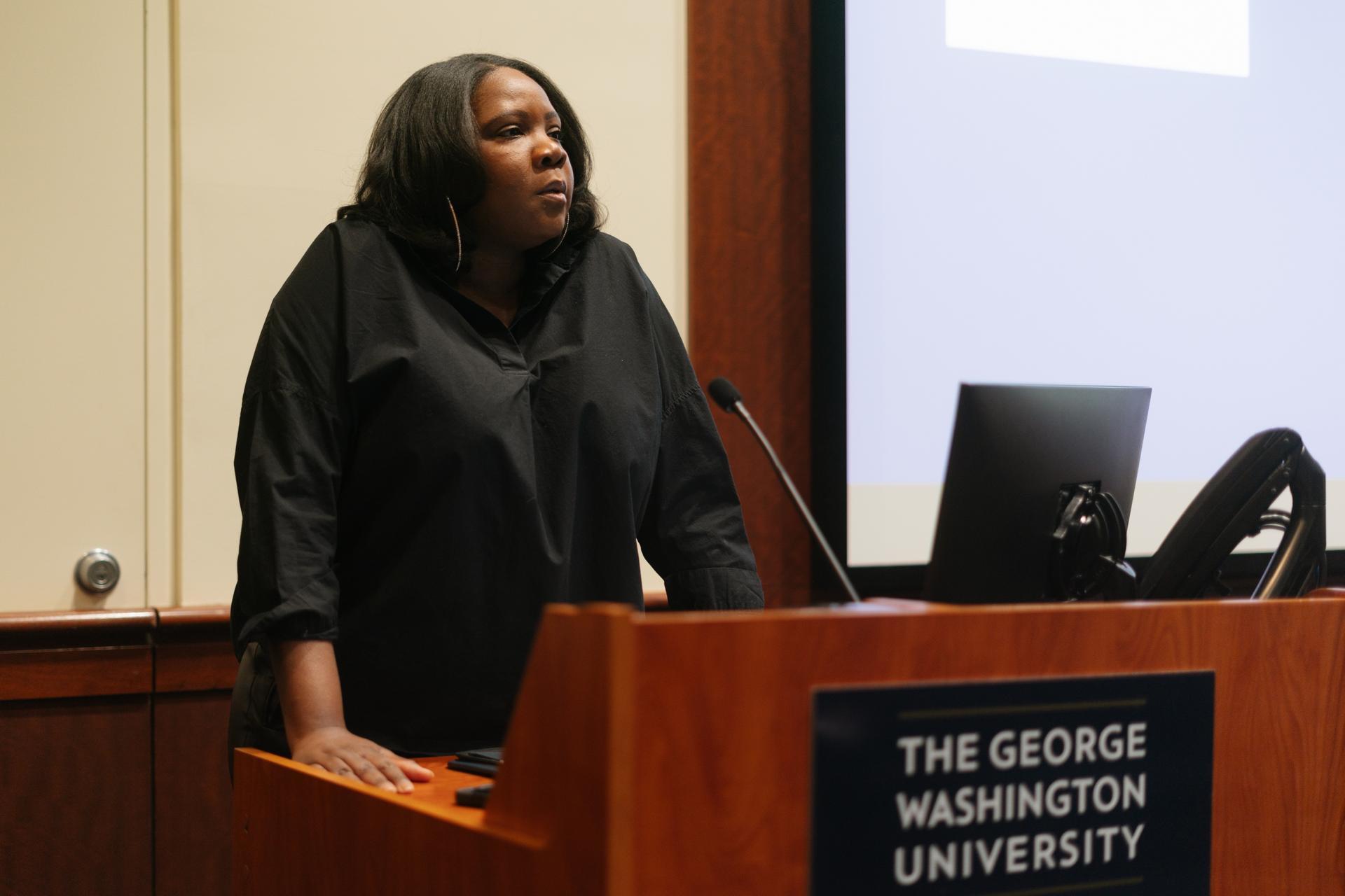 Dr. Adjoa Asamoah delivers speech from behind podium