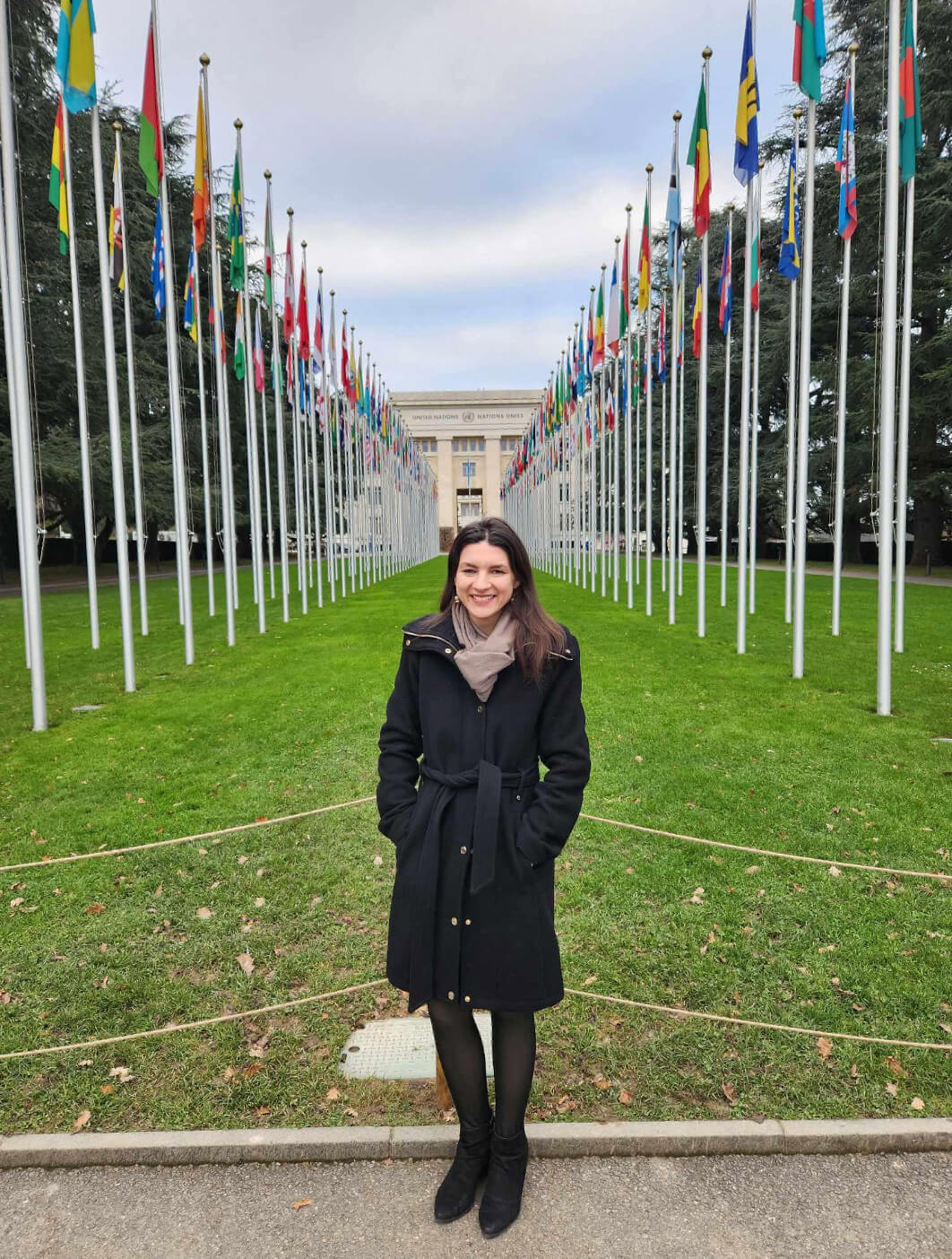 Hatch poses in front of the Palais des Nations and the walkway of flags