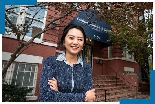 Zhongxin Zheng smiles at camera in front of GSEHD building