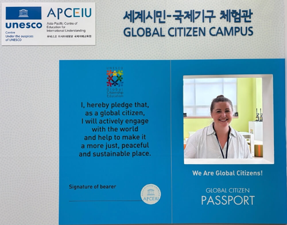 ): An image that is intended to resemble a passport and reads “Global Citizen Passport” and features Isabelle Cooksey’s face. There is a pledge that reads: “I, hereby pledge that, as a global citizen, I will actively engage with the world and help to make it a more just, peaceful, and sustainable place.” 