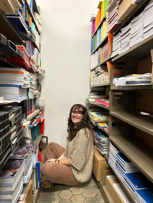 Megan sits on the floor in the UIL publications reserves
