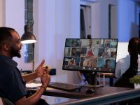 male speaks to group during webinar meeting in his office - photo credit: DCStudio on Freepik