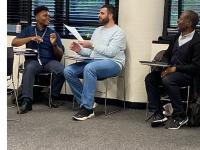 Dex Burns (left) and Mohanad Alsaid (right) in class with professor Ramien R. Pierre
