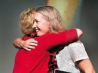 Marlies Mulkhuyse (right) gets a hug from Marla Demerly after Mulkhuyse is named Teacher of the Year