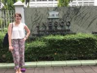 Brynn poses in front of the UNESO sign