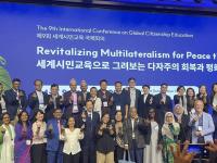 group photo of attendees at the 9th International Conference on Global Citizenship Education; Micha is included on the front row on the right