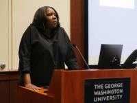Dr. Adjoa Asamoah delivers speech from behind podium