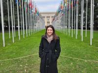 Hatch poses in front of the Palais des Nations and the walkway of flags
