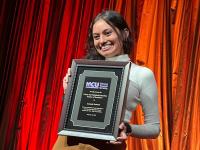 Amanda Deebrah proudly holds award