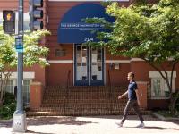 student walks toward GSEHD building