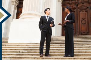 education policy professional meets with policymaker on the steps of a large courthouse