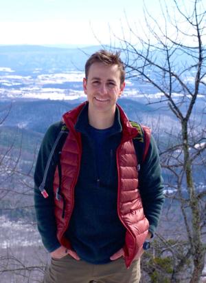 Justin Rotunda    (poses in front of expansive background while hiking)