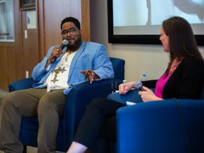Gabriel "Asheru" Benn speaks on microphone at Conversations that Matter event