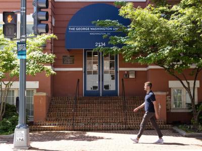 student walks toward GSEHD building
