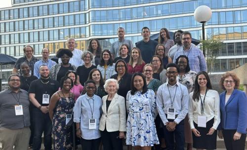 Partipants of the 2024 Fellowship and Summer Institute on Antisemitism & Jewish Inclusion pose for a group photo with Auschwitz survivor Irene Weiss