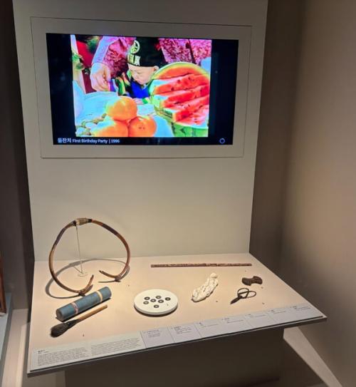 A museum display that shows traditional items placed in front of a baby at their Doljabi