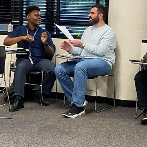 Dex Burns (left) and Mohanad Alsaid (right) in class with professor Ramien R. Pierre