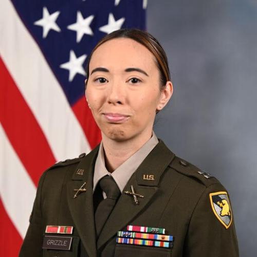 Capt. Catherine Grizzle headshot in military uniform and American flag in the background