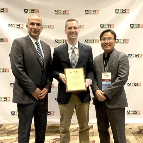 Dr. Oliver (Ozzie) Crocco (center) is awarded the Early Career Scholar Award