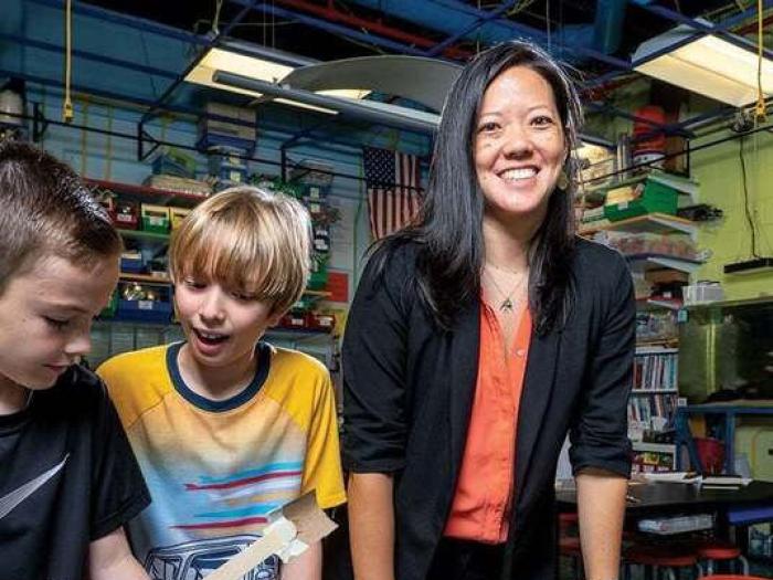 Stephanie Lin pictured with two students in a science lab. Photo used in Arlington Magazine courtesy of Skip Brown.