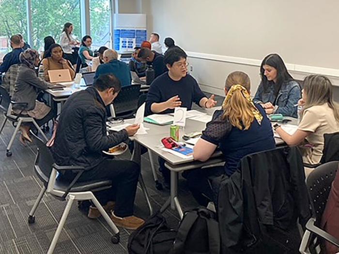participants in the GSEHD Research Kaleidoscope discuss their projects in small groups