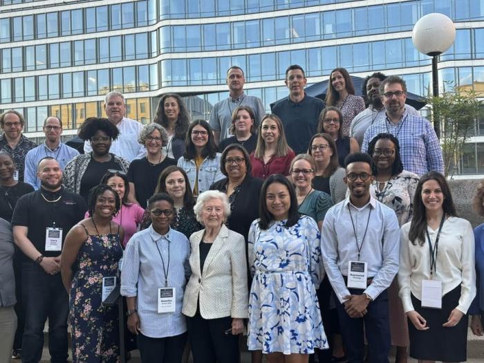 Partipants of the 2024 Fellowship and Summer Institute on Antisemitism & Jewish Inclusion pose for a group photo with Auschwitz survivor Irene Weiss