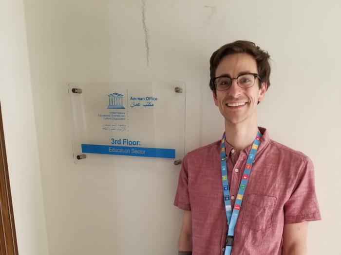 Justin poses for a photo outside the education unit’s office