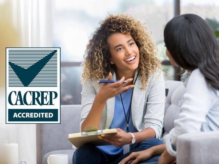 CACREP Accredited (photo of counselor speaking to client)